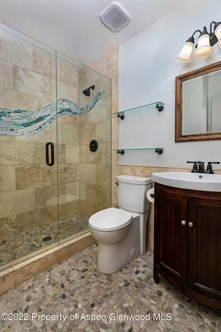 a bathroom with a sink toilet and shower