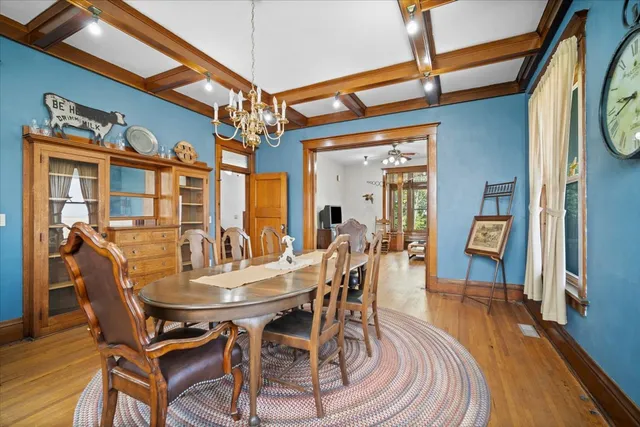 a kitchen with stainless steel appliances granite countertop a stove a sink dishwasher and a dining table with cabinets