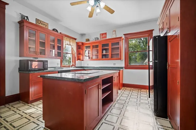 a kitchen with stainless steel appliances granite countertop a refrigerator and a stove top oven
