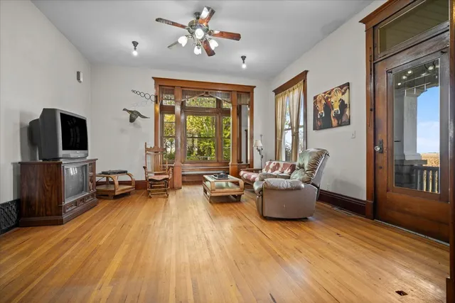a living room with furniture window and wooden floor