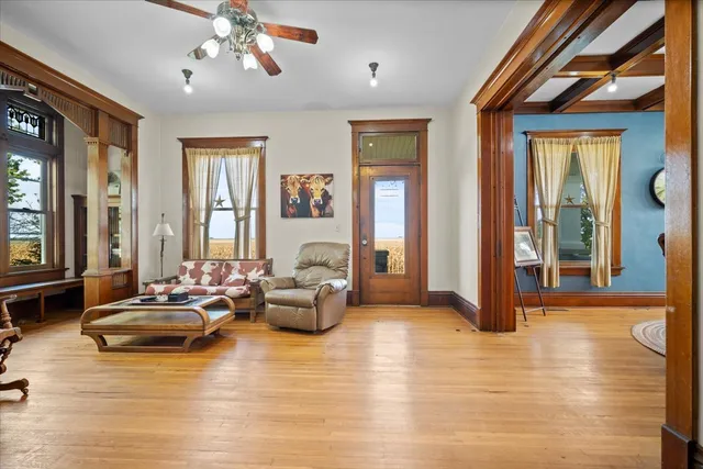 a living room with furniture a window and a flat screen tv