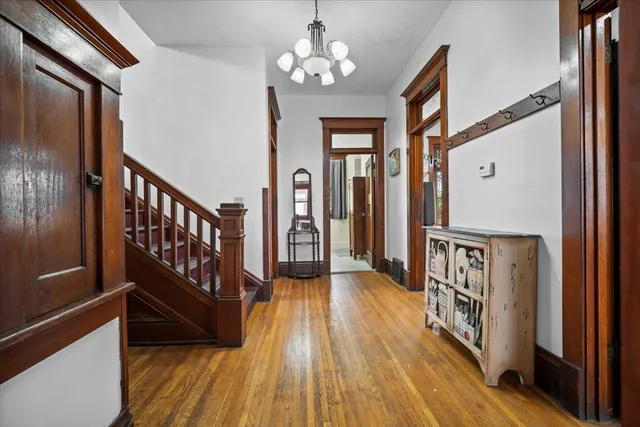 a view of entryway and hall with wooden floor