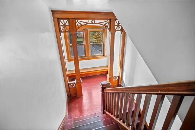 a view of staircase with railing and white walls