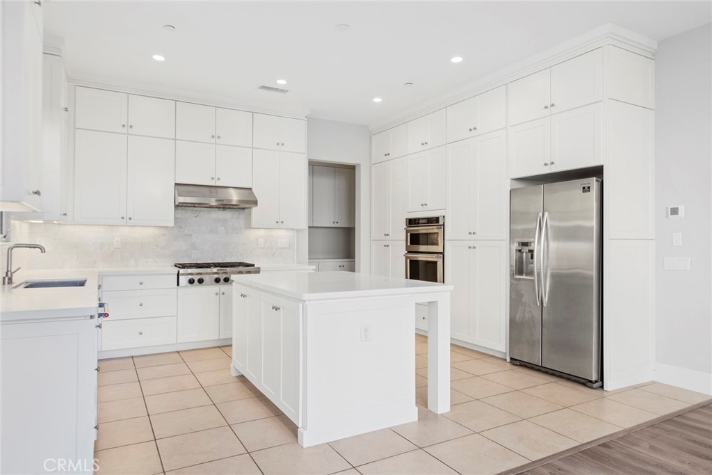 133 Donati Irvine, CA 92602 - Photo 7 of 20 a kitchen with stainless steel appliances a refrigerator sink and cabinets