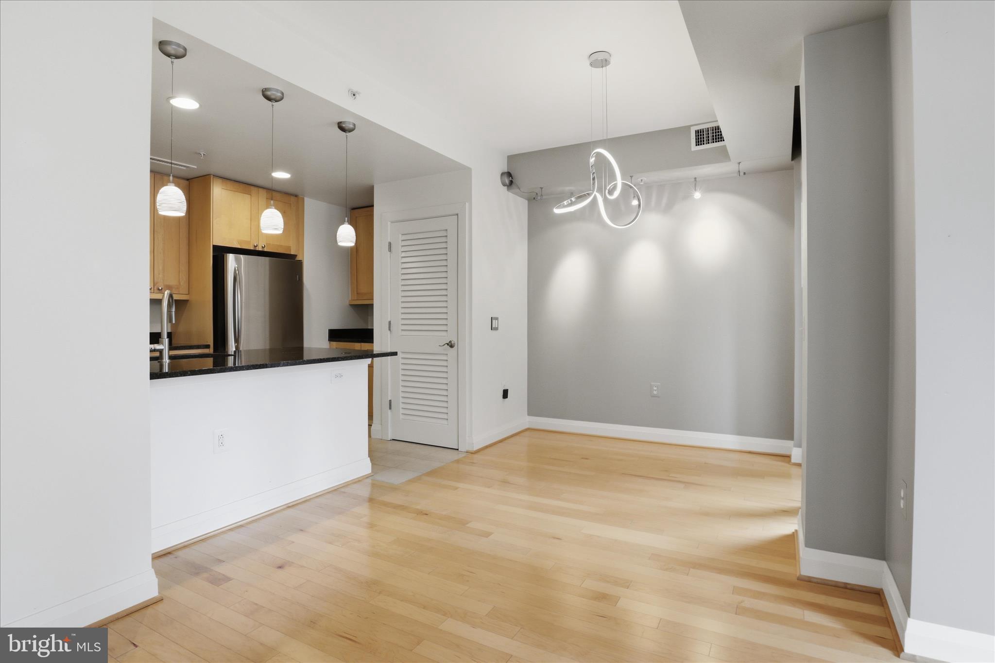 11990 Market Street, Unit 216 Reston, VA 20190 - Photo 18 of 41 a view of a room with wooden floor and mirror