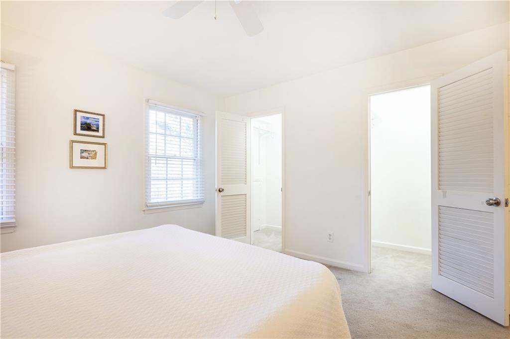 1101 Collier Road Northwest, Unit I3 Atlanta, GA 30318 - Photo 16 of 24 a bedroom with a bed and a window