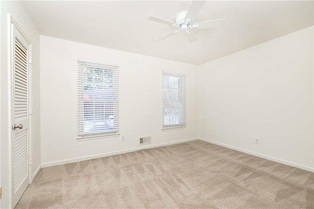 1101 Collier Road Northwest, Unit I3 Atlanta, GA 30318 - Photo 18 of 24 an empty room with a window and a ceiling fan