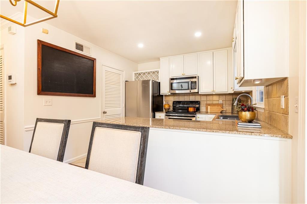 1101 Collier Road Northwest, Unit I3 Atlanta, GA 30318 - Photo 10 of 24 a view of a living room with a flat screen tv