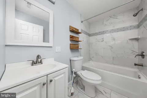 a bathroom with a sink a toilet and a bathtub