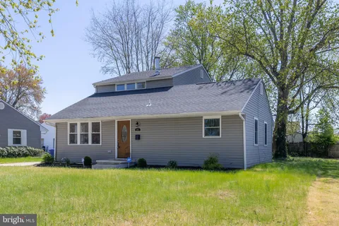 a backyard of a house with yard and tree s