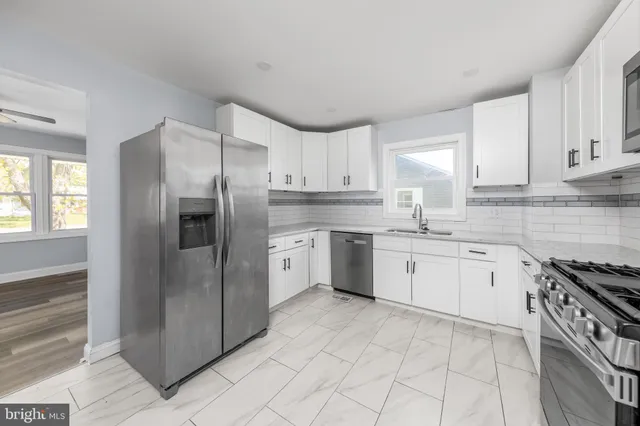 a kitchen with stainless steel appliances granite countertop a refrigerator sink and cabinets