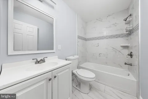 a bathroom with a sink a toilet and a bathtub