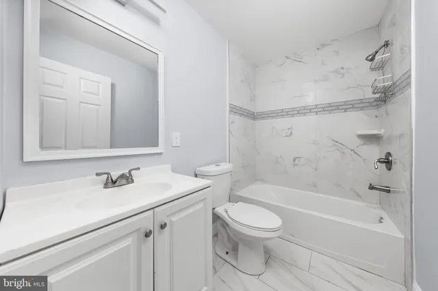 a bathroom with a sink a toilet and a bathtub