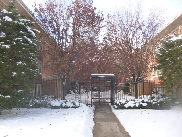 7530 North Ridge Boulevard, Unit 3W Chicago, IL 60645 - Photo 2 of 23 a wooden bench sitting in front of a building