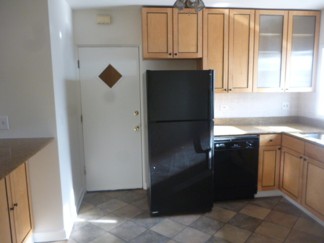 7530 North Ridge Boulevard, Unit 3W Chicago, IL 60645 - Photo 7 of 23 a kitchen with a refrigerator and a sink
