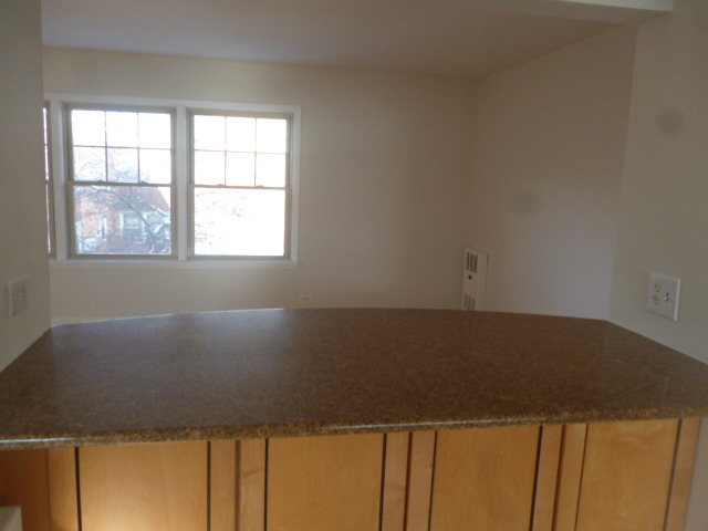 7530 North Ridge Boulevard, Unit 3W Chicago, IL 60645 - Photo 9 of 23 an empty room with wooden floor