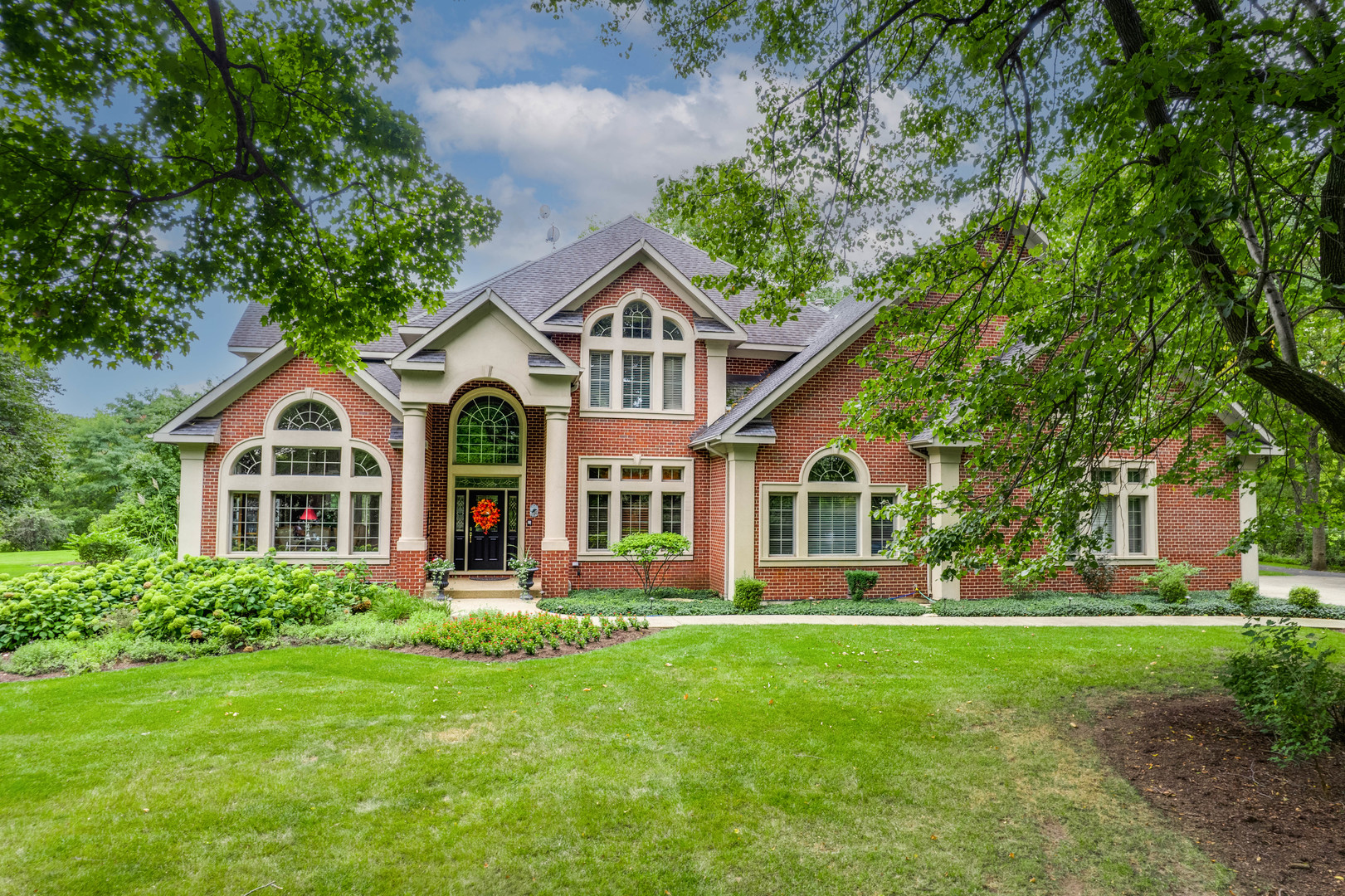 5N156 Dunham Road St. Charles, IL 60174 - Photo 2 of 65 a front view of a house with a yard and trees