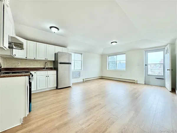 a kitchen with wooden floors and white appliances