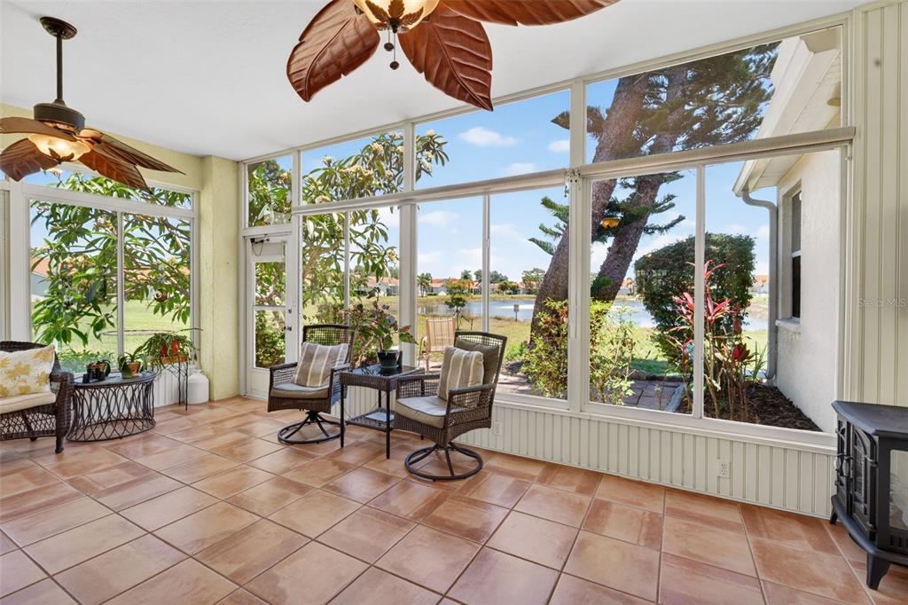 4266 Summertree Road Venice, FL 34293 - Photo 5 of 64 a view of a patio with dining table and chairs