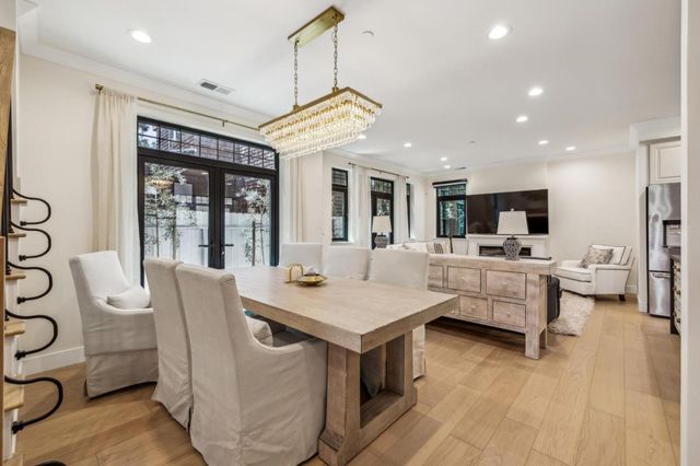 a large white kitchen with a large window