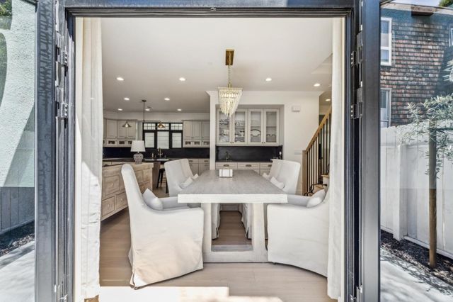a living room with furniture and kitchen view
