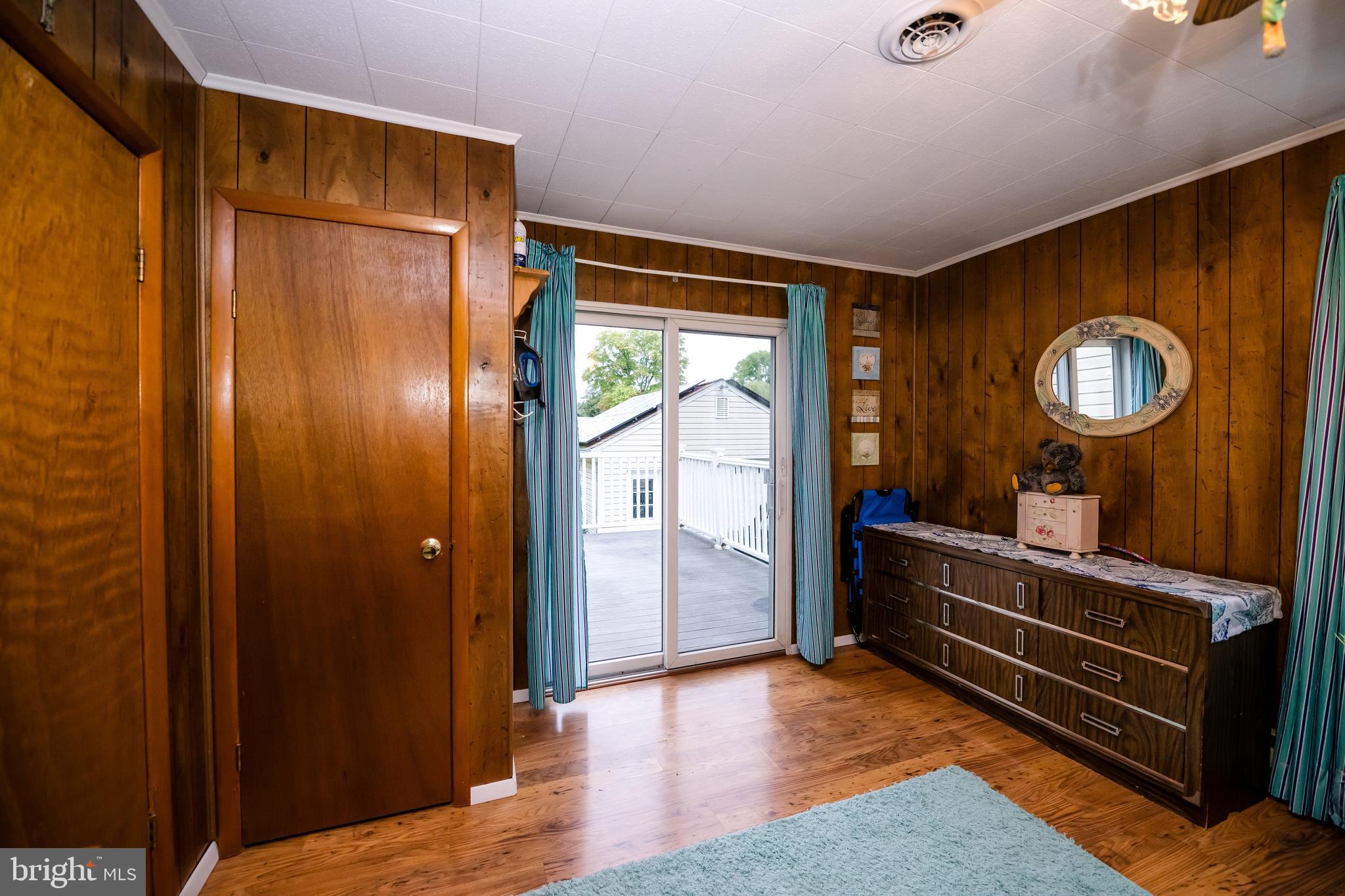 1107 Maple Road Essex, MD 21221 - Photo 35 of 42 a bedroom with a bed and a mirror