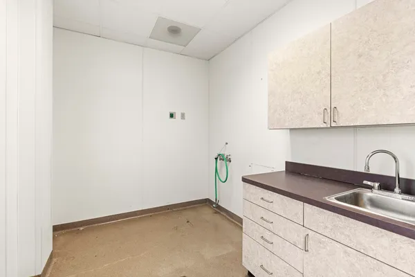 a kitchen with a sink and cabinets