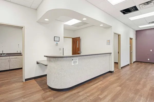 a room with wooden floor and white walls