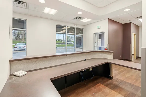 a kitchen with stainless steel appliances cabinets and a large window