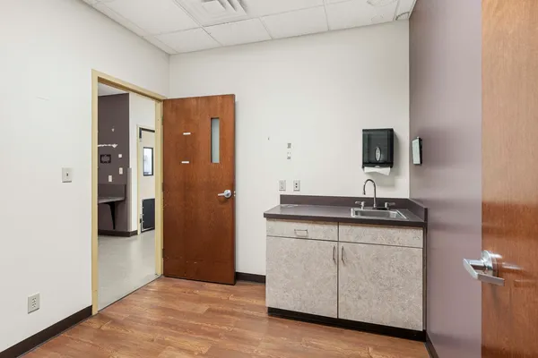 a kitchen with granite countertop a sink and a refrigerator