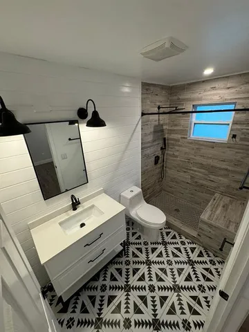 a bathroom with a sink toilet and shower