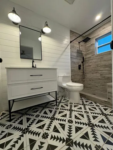 a bathroom with a sink toilet and mirror