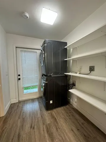 a room with walk in closet and wooden floor