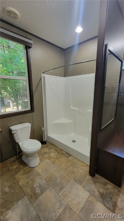 129 Locust Drive Bracey, VA 23919 - Photo 13 of 27 a bathroom with a granite countertop sink a toilet a mirror and a glass door shower