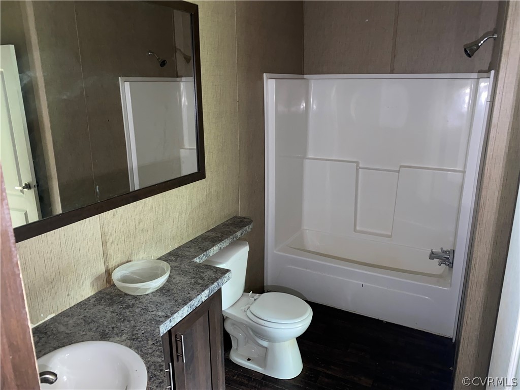 129 Locust Drive Bracey, VA 23919 - Photo 15 of 27 a bathroom with a granite countertop sink mirror vanity and toilet