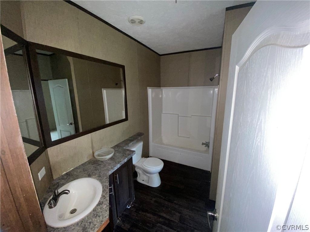 129 Locust Drive Bracey, VA 23919 - Photo 16 of 27 a bathroom with a sink a toilet and shower