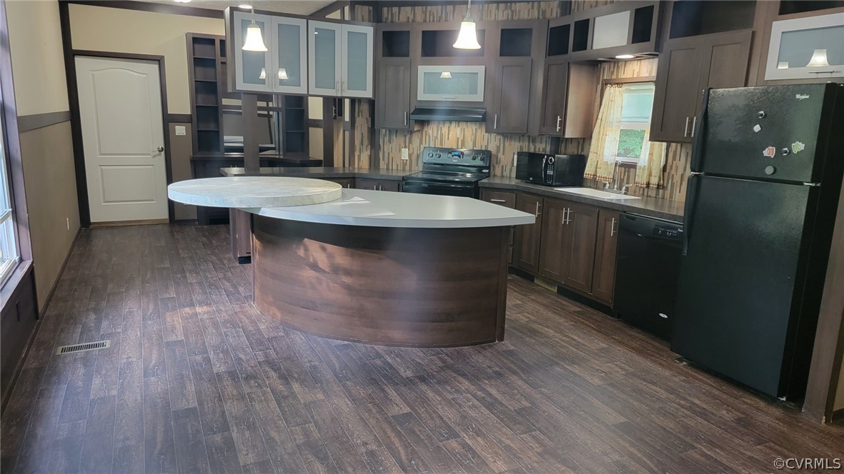 129 Locust Drive Bracey, VA 23919 - Photo 2 of 27 a kitchen with stainless steel appliances a sink cabinets and wooden floor