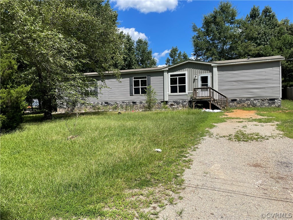 129 Locust Drive Bracey, VA 23919 - Photo 25 of 27 a view of a yard with a house and a yard