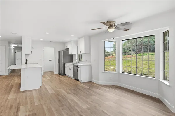 a view of a kitchen with furniture and a ceiling fan