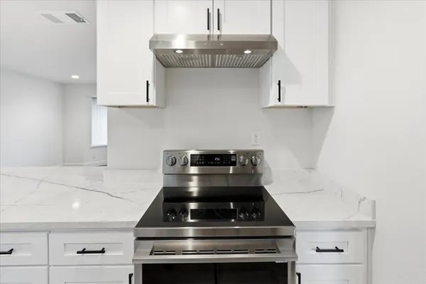 a stove top oven sitting inside of a kitchen