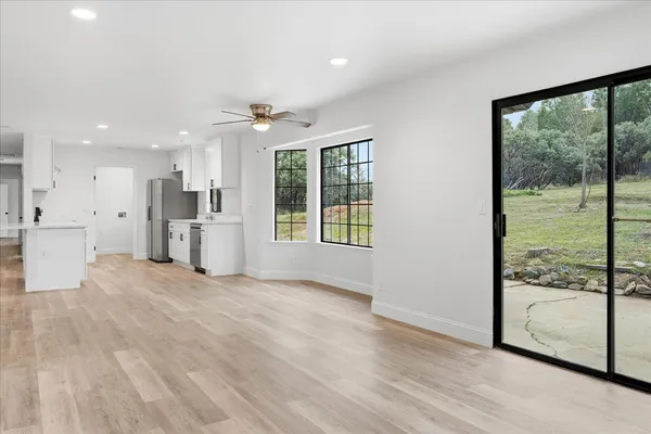 a view of a kitchen with large windows