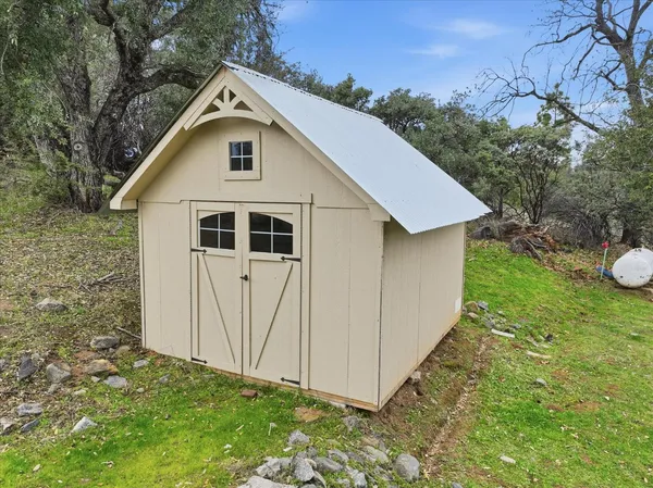 a view of a white house with a yard