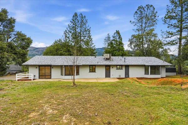 a front view of a house with a garden