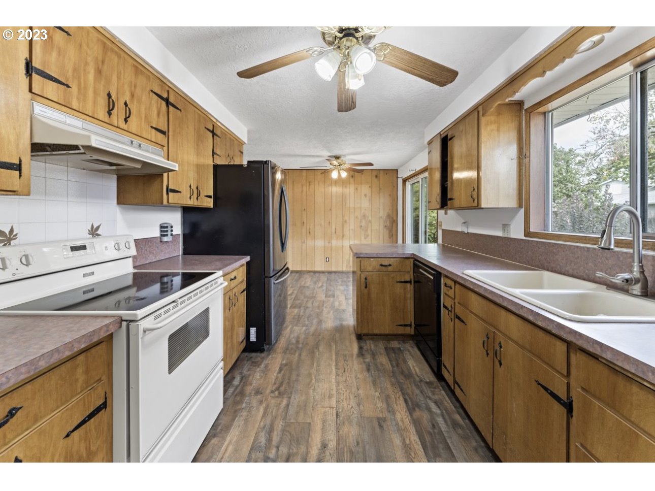 2747 32nd Street Springfield, OR 97477 - Photo 6 of 17 a kitchen with a sink appliances wooden floor and a large window