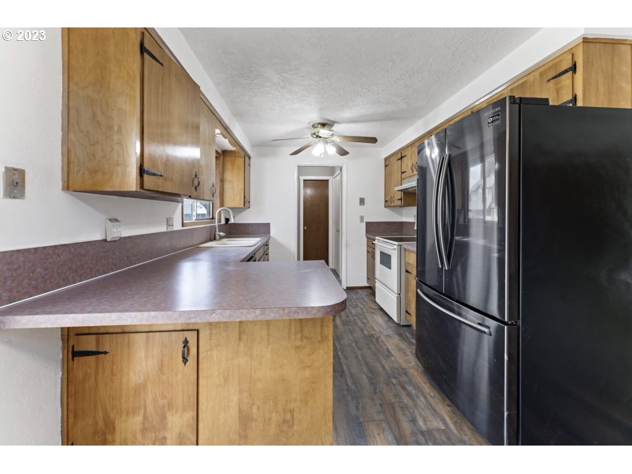 2747 32nd Street Springfield, OR 97477 - Photo 7 of 17 a kitchen with kitchen island a counter top space cabinets and stainless steel appliances