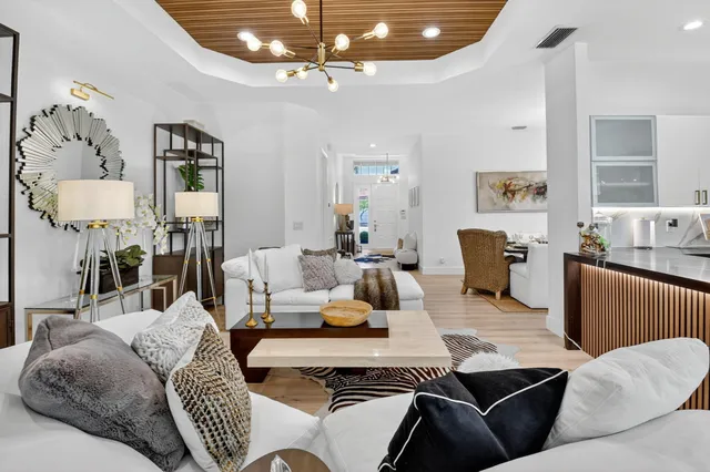 a dining room with wooden floor and a floor to ceiling window