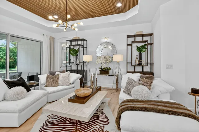 a view of a dining room with furniture a chandelier and wooden floor