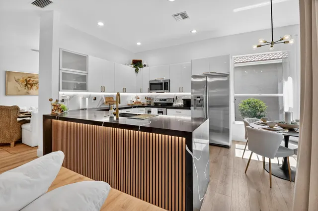 a kitchen with a sink a counter top space a stove and cabinets