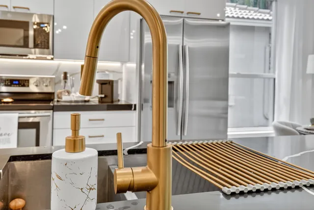 a kitchen with appliances a sink and cabinets