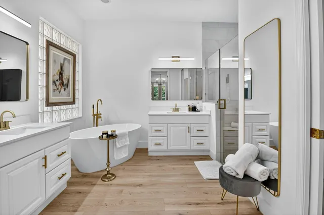 a dining room with furniture a chandelier and wooden floor